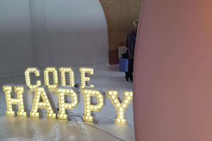A set of illuminated letters spelling out Code Happy