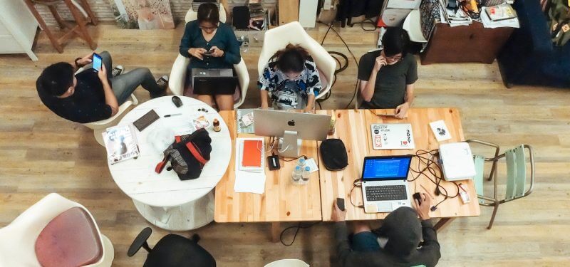 Group of developers working at a table looking from above