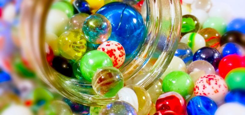 Marbles coming out of a jar