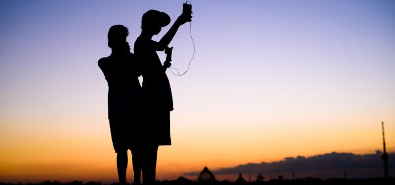 Silhouette of mobile users searching for signal