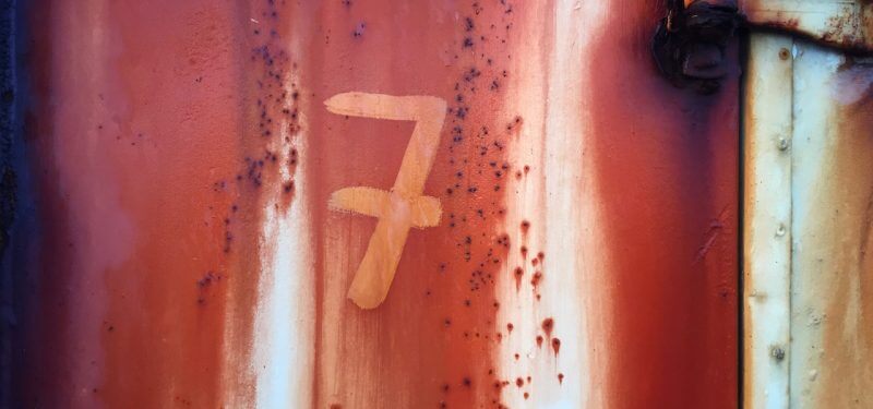 Number 7 on rusty wall