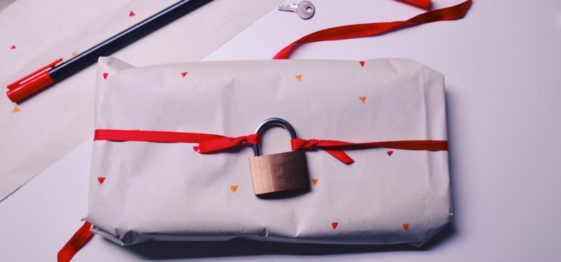 Present wrapped with a lock tied to the bow