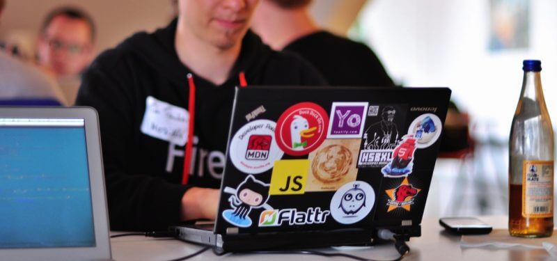 Laptop with stickers including JS logo