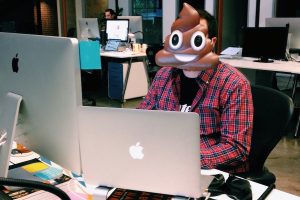 Developer with poop emoji mask on