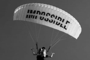 White parachute with impossible written in black upon the canopy