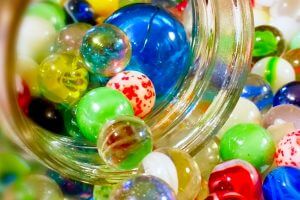 Marbles coming out of a jar