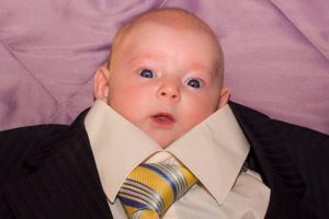 A baby in an adult-sized suit