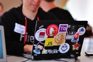 Laptop with stickers including JS logo