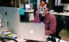Developer with poop emoji mask on