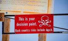 Red and white sign displayed at Snowmass, near Aspen, Colorado, warning of potentailly deadly concequences of going further.