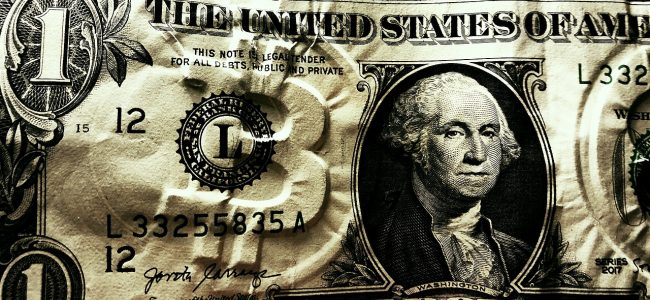 Dollar bill with embossed Bitcoin logo