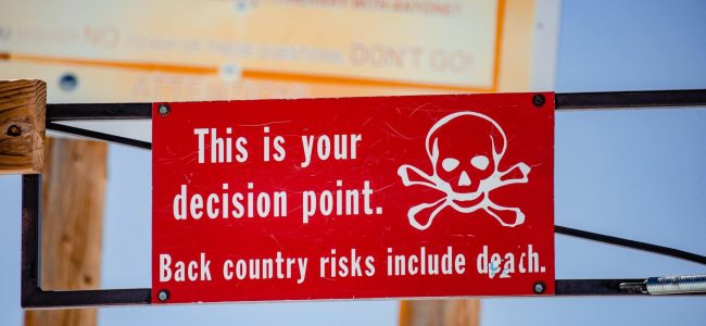 Red and white sign displayed at Snowmass, near Aspen, Colorado, warning of potentailly deadly concequences of going further.