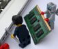 Robot lego helping lego man fix computer
