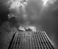 High rise office building reaches up toward a cloudy sky